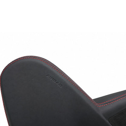Factory AIRBAG marking retained on a leather wrapped seat side trim panel with red contrast stitching